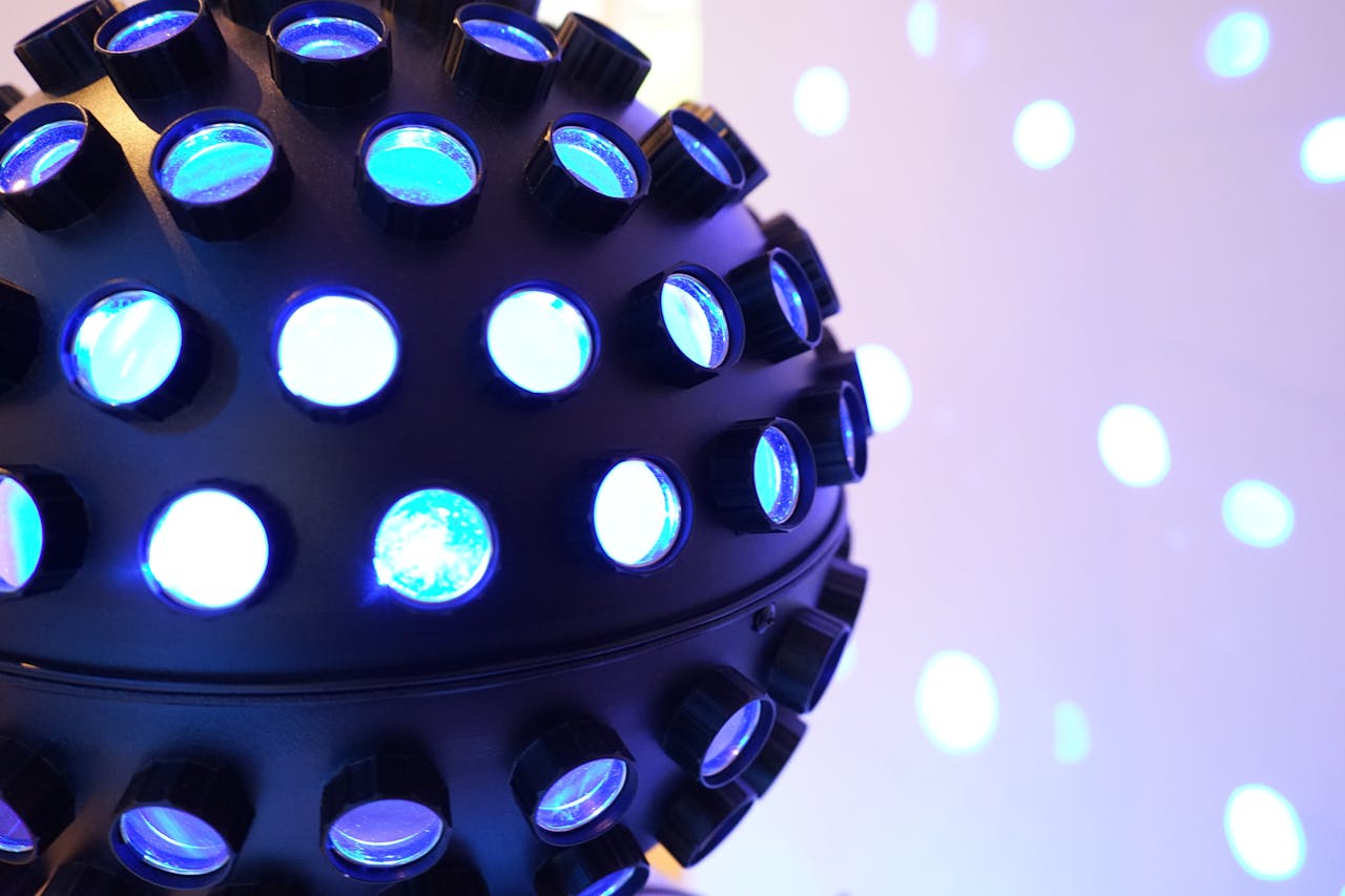 Vibrant blue disco ball glowing in a dimly lit room, perfect for party themes.